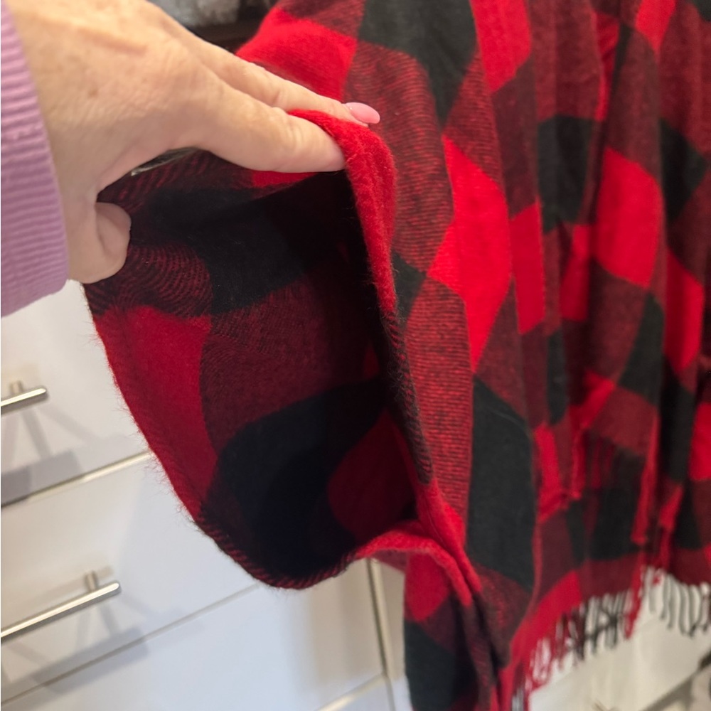 Red and Black Plaid sweater jacket.  Has pockets and fringe. Very cute